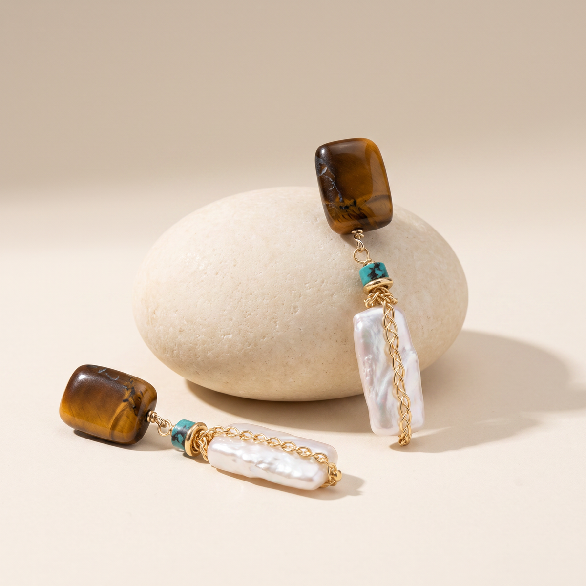 Amber Hour earrings resting on a pale stone