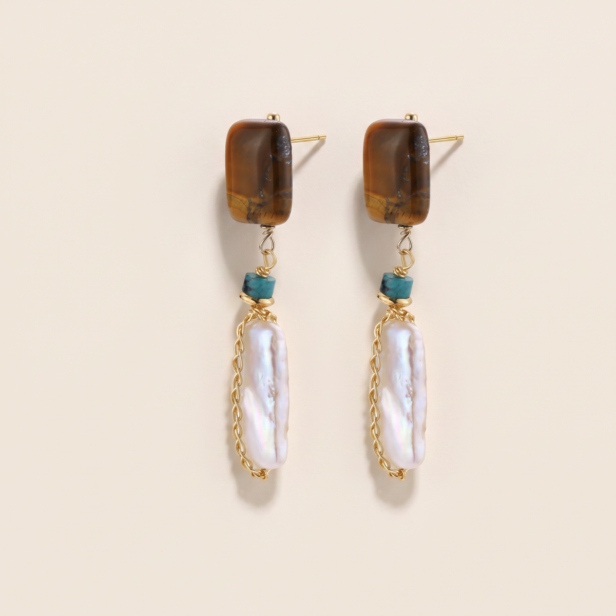 Amber Hour earrings, the pair laid flat, tiger's eye stud with turquoise and a long pearl drop