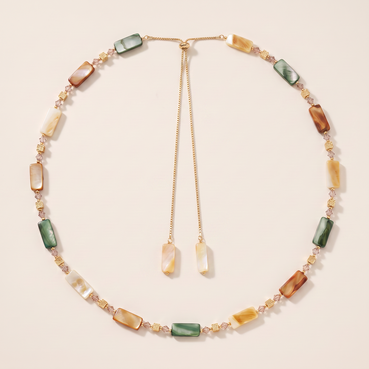 Armour necklace laid flat, shell and agate tiles in green, amber and cream with a bolo slider
