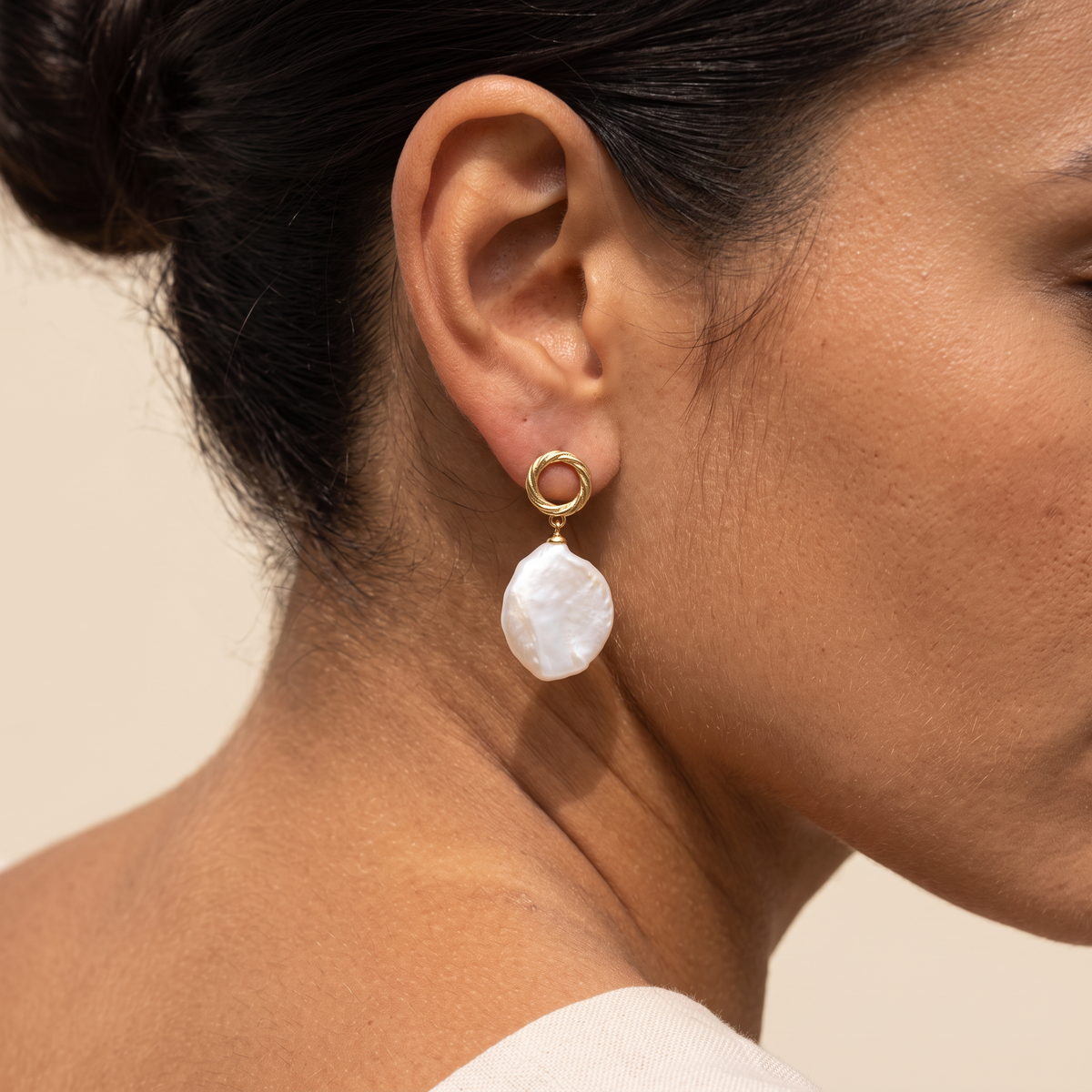 First Tide earring worn, close on the ear