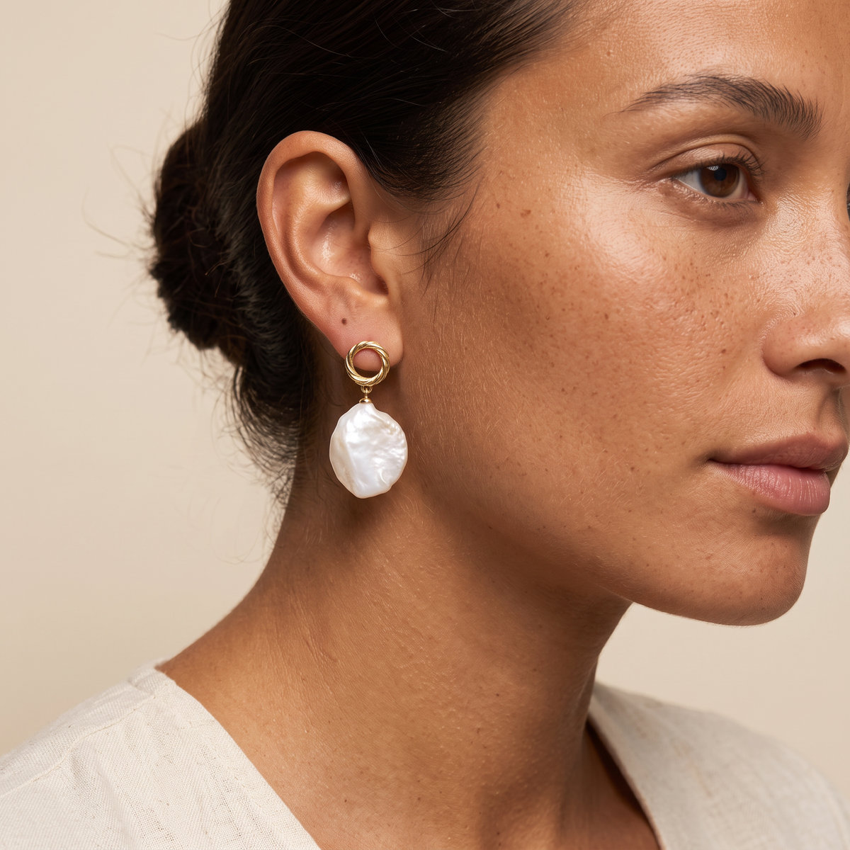 First Tide earring worn, shown against the jaw