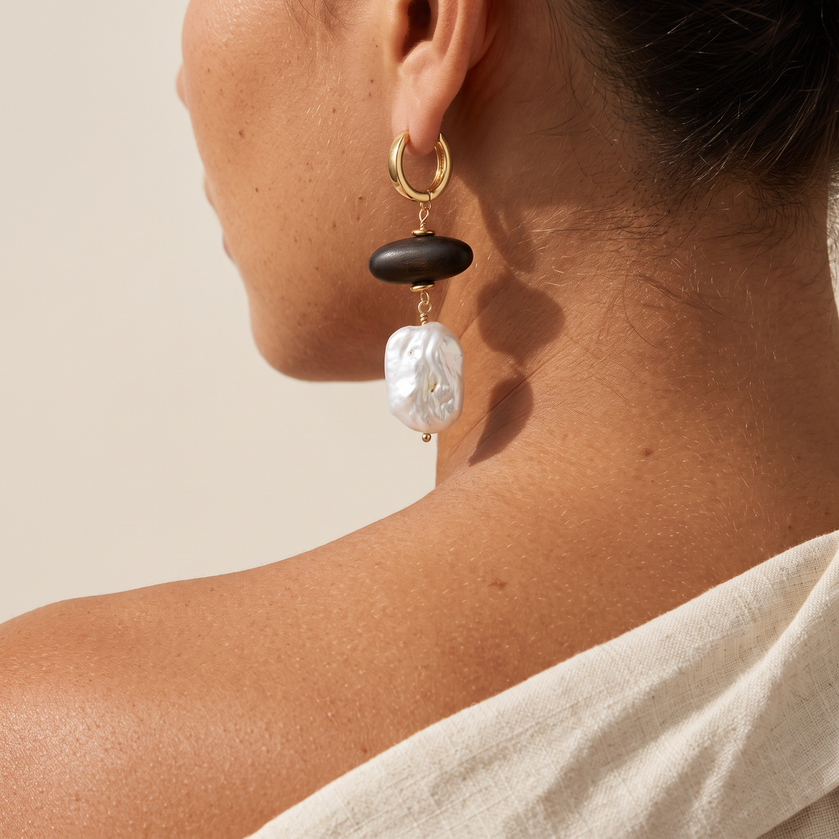 Grounded earring worn, seen over the shoulder