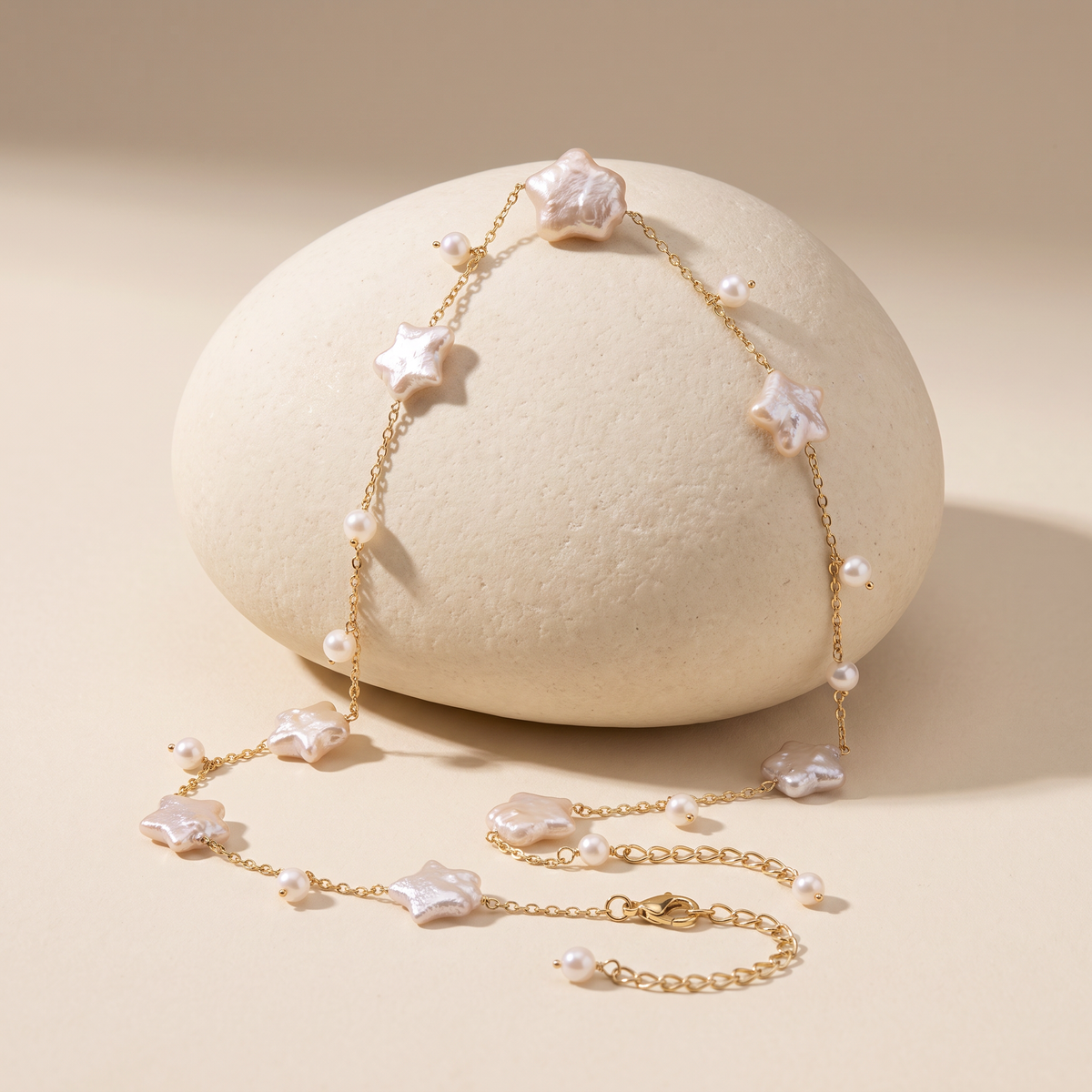 Night Passage necklace resting on a pale stone