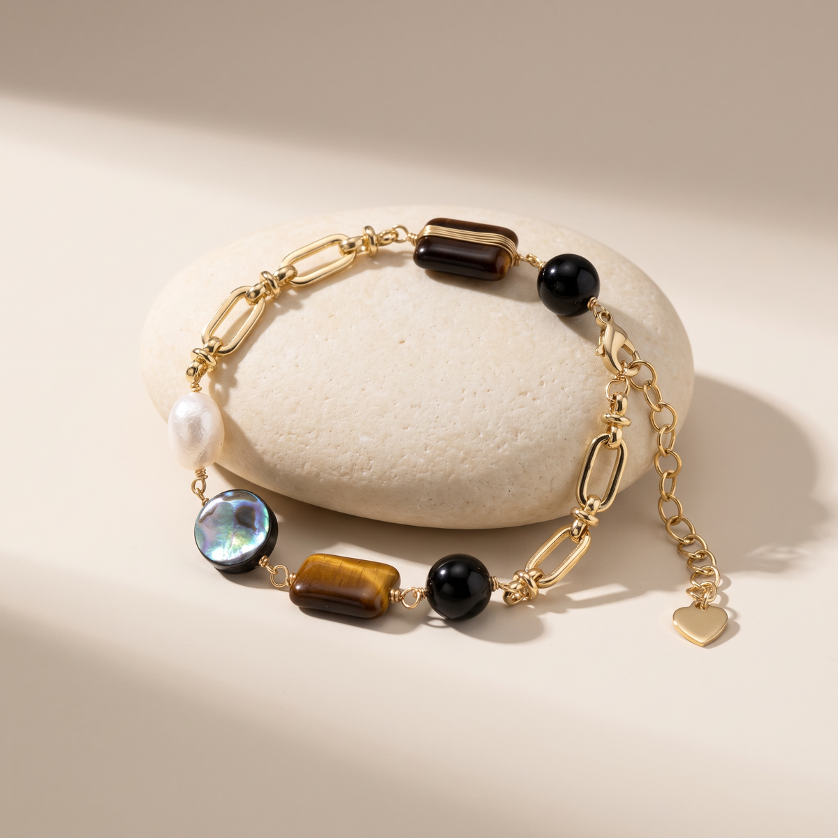 Obsidian Hour bracelet resting on a pale stone