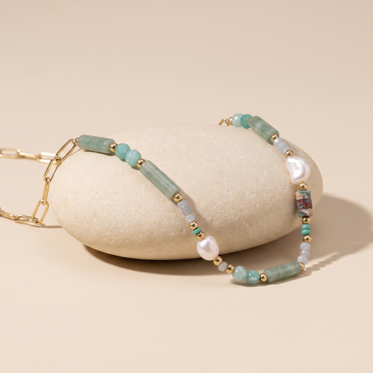 Sea Glass necklace resting on a pale stone