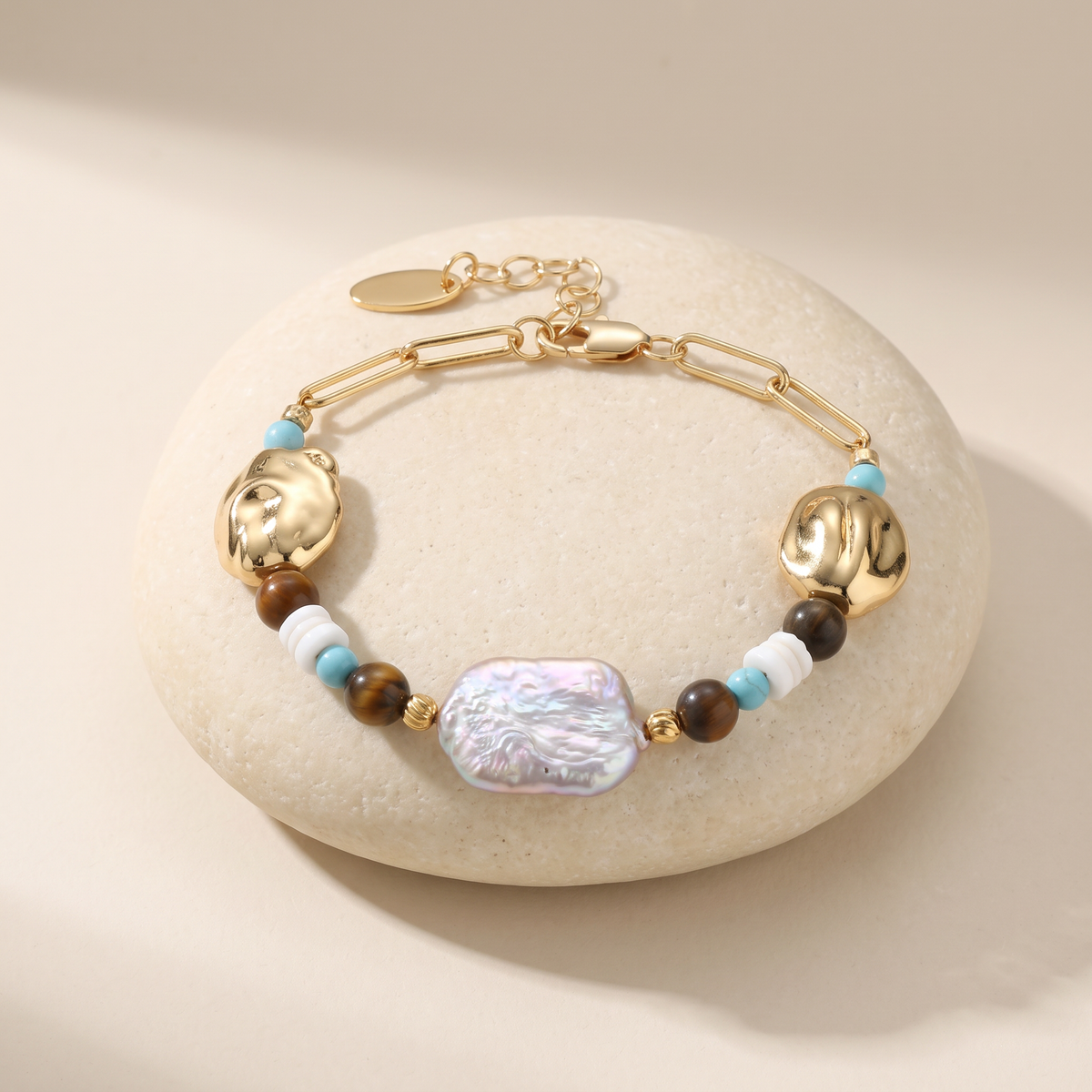 Compass bracelet resting on a pale stone
