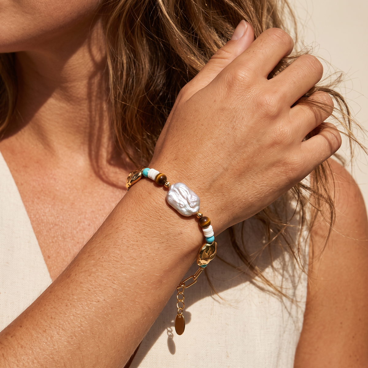Compass bracelet worn, hand in the hair