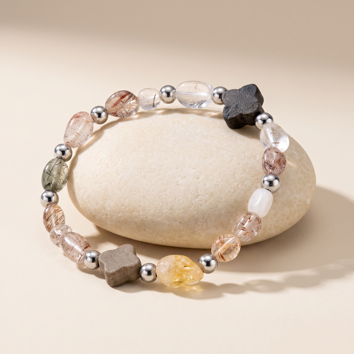 Ember bracelet resting on a pale stone