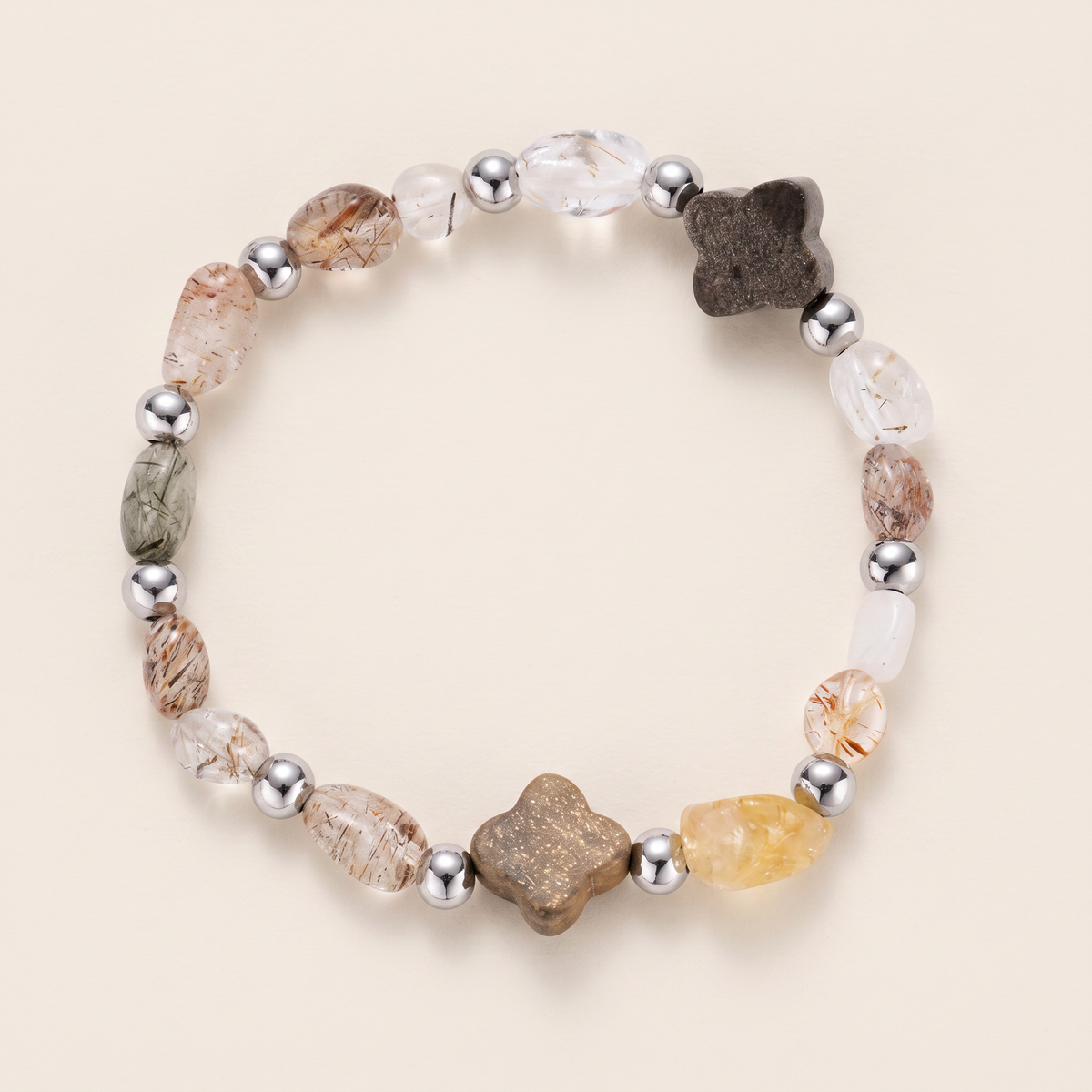 Ember bracelet laid flat, rutilated quartz and clear quartz with silver-tone spacers