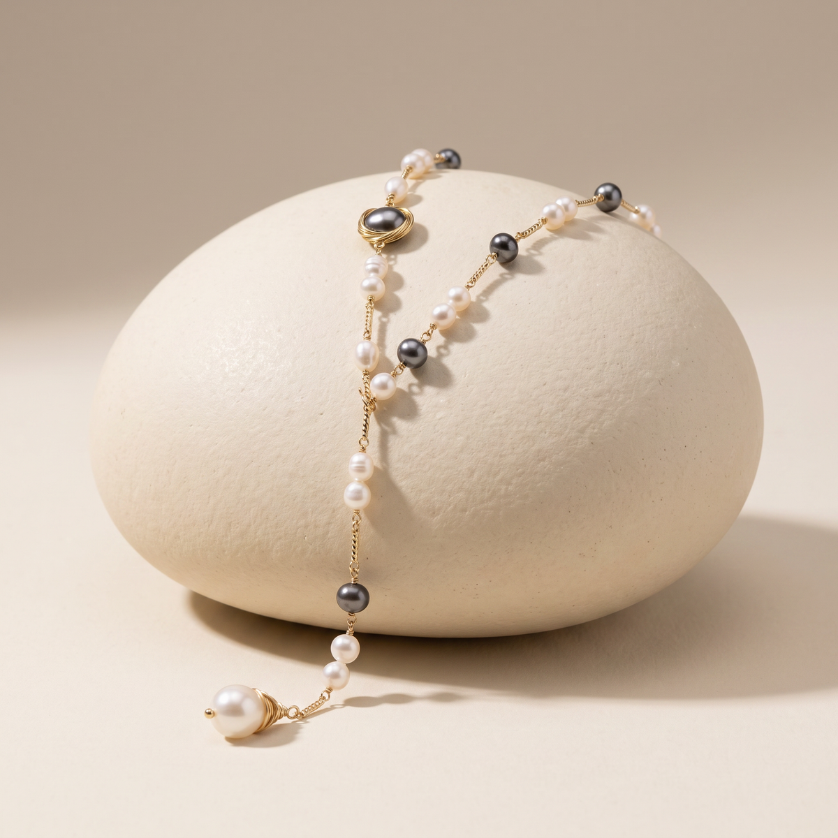 Evening Hour necklace resting on a pale stone