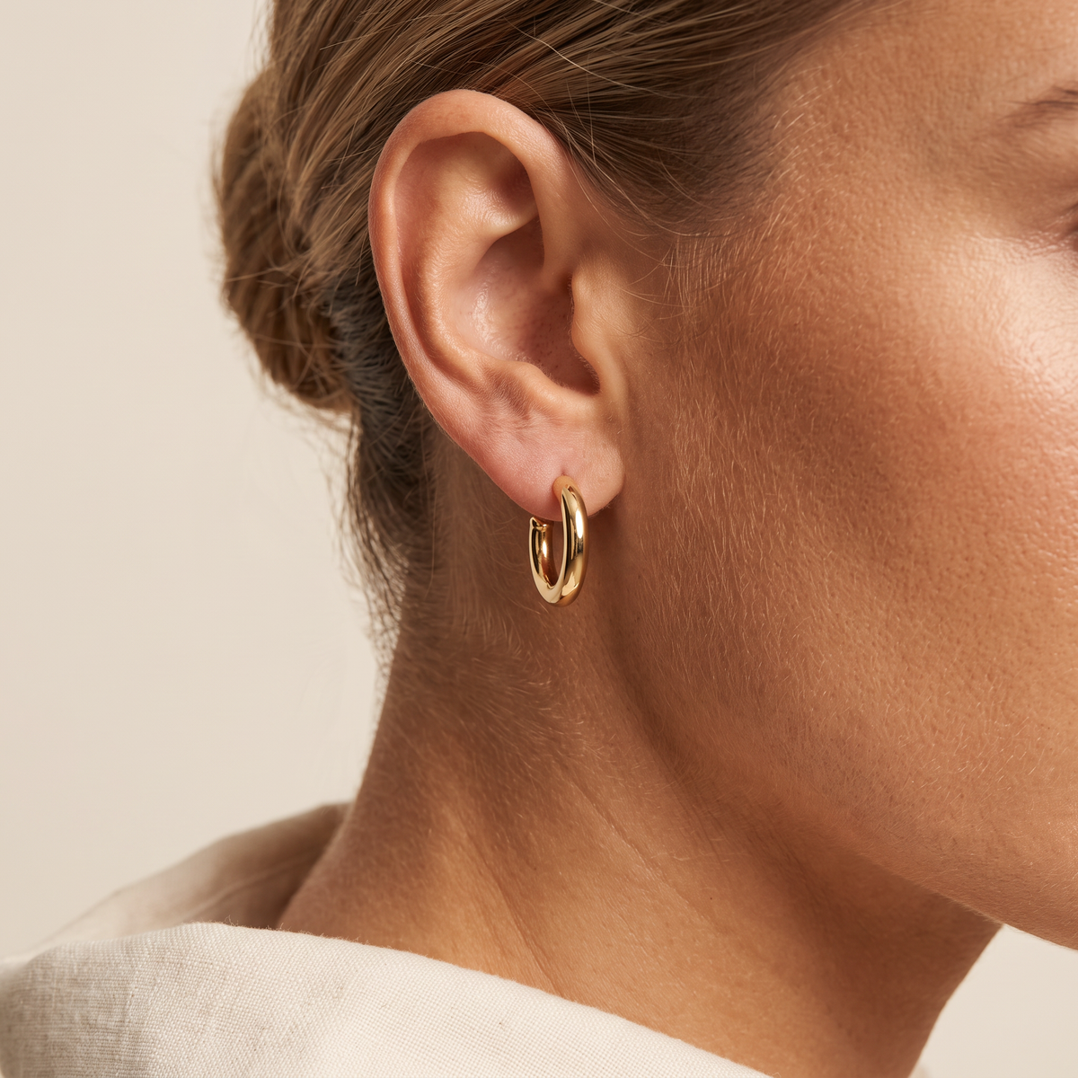 Iridescent earring worn as a plain hoop, charm removed