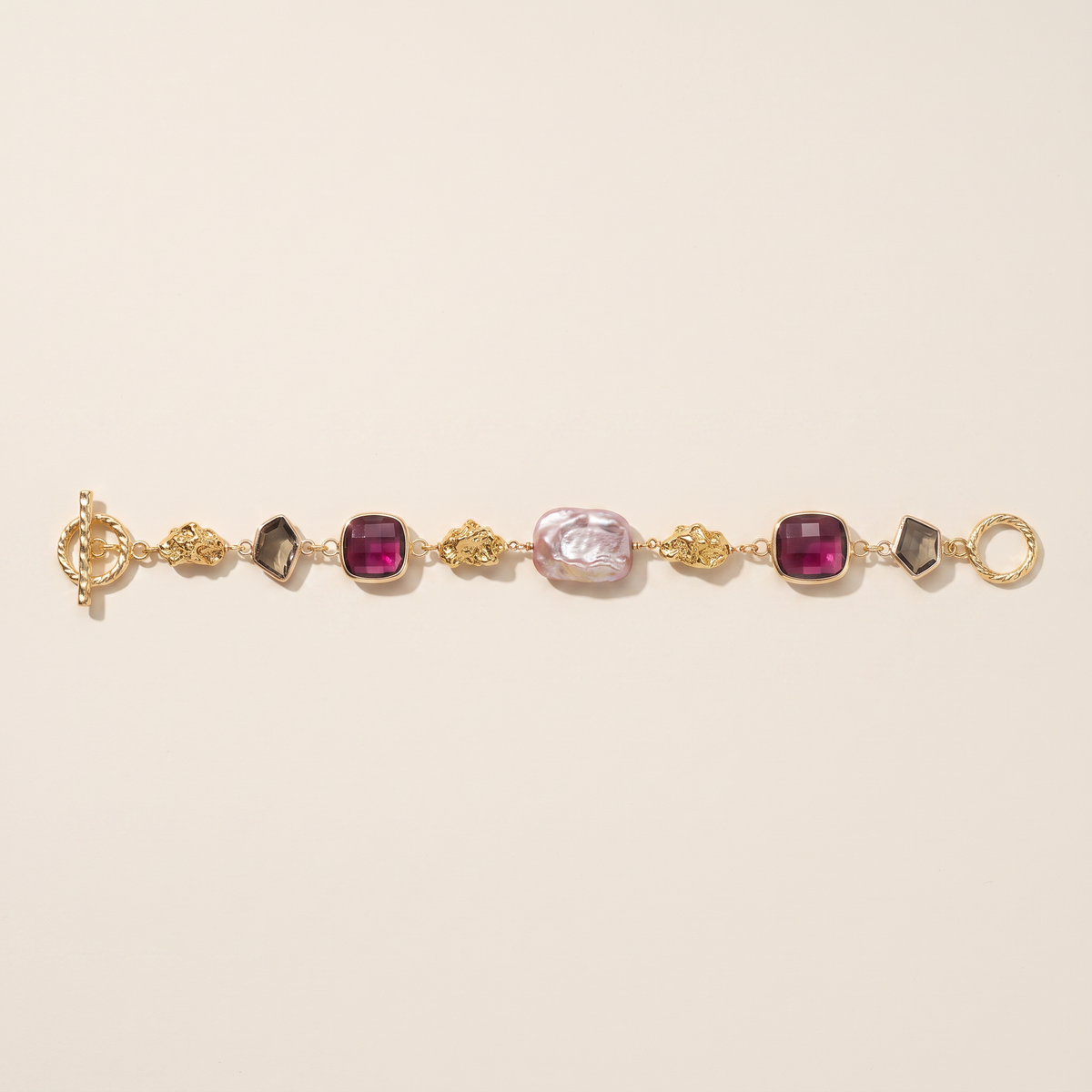 Midnight bracelet laid flat, garnet and smoky quartz with baroque pearls, gold nuggets and a toggle clasp