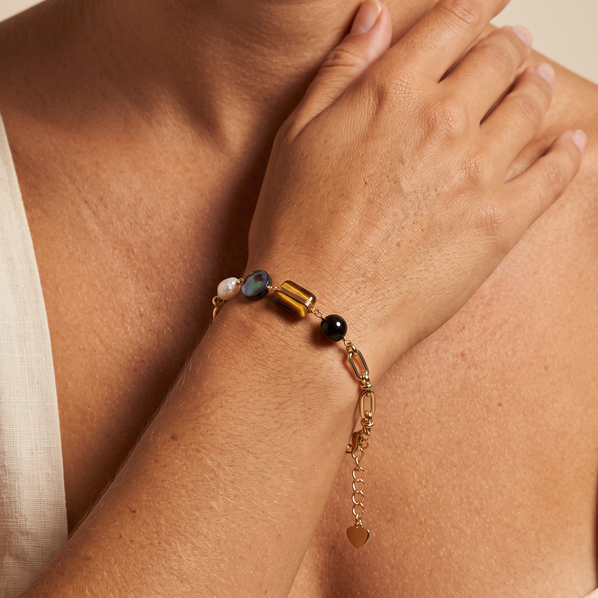 Obsidian Hour bracelet worn, hand raised to the shoulder