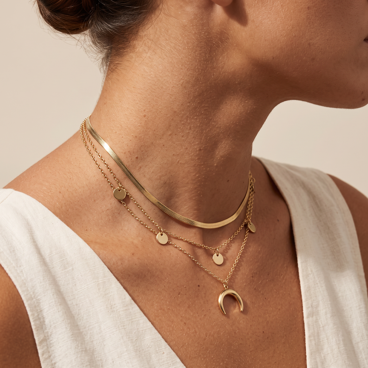 Three Moons necklace worn, close on the crescent